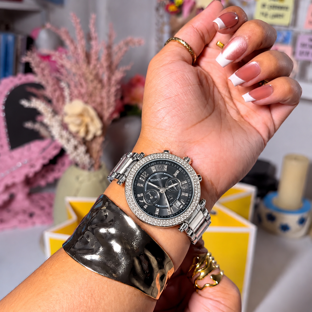 MK Parker Silver Black Dial watch worn on a woman's wrist