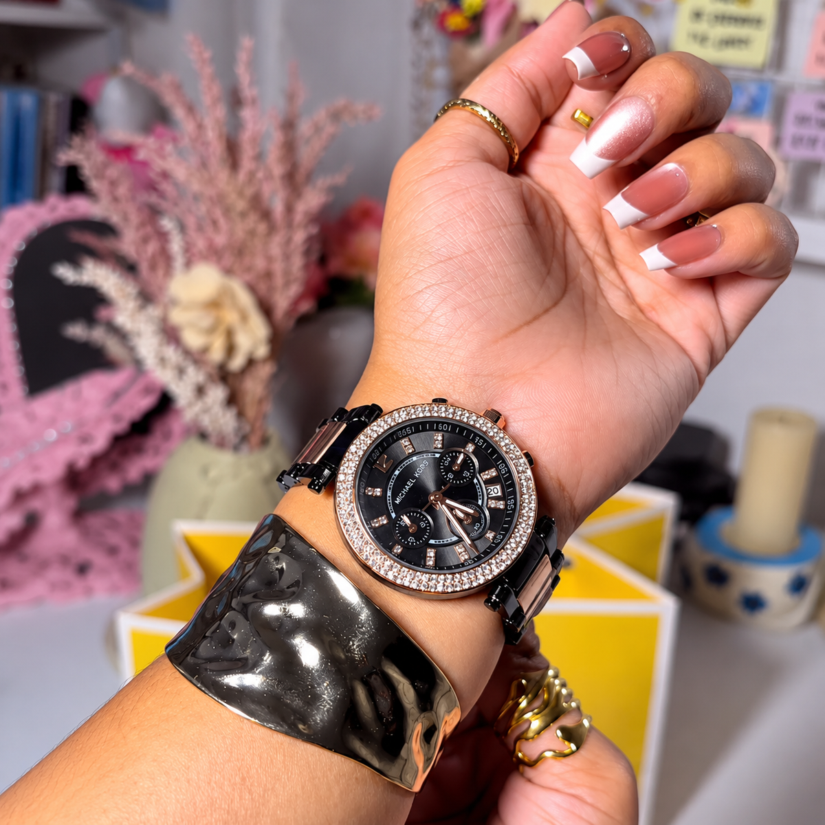 MK Parker Black Gold watch worn on a woman's wrist