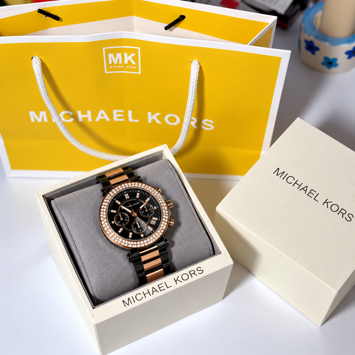 MK Parker Black Gold watch shown with its box and carry bag