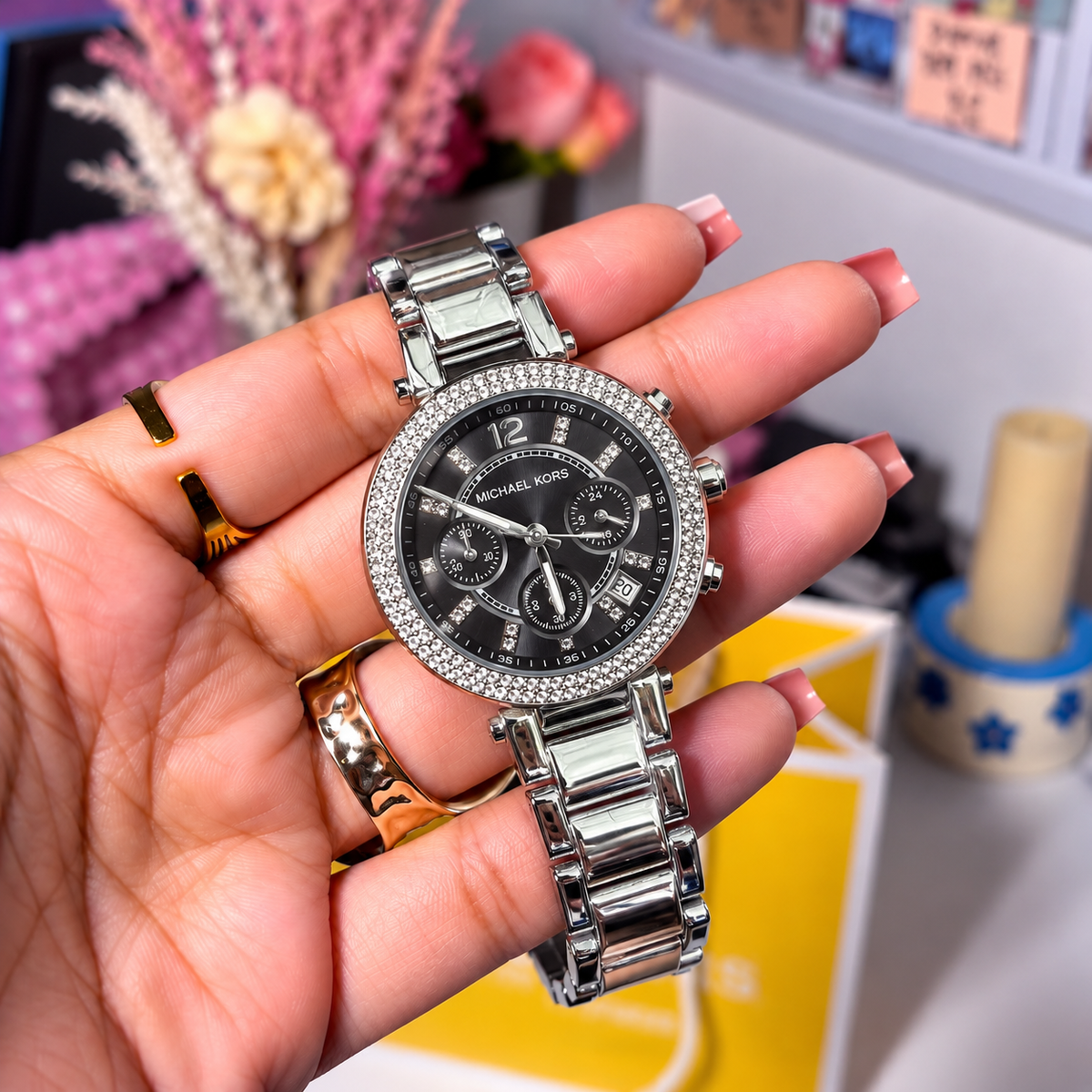 MK Parker Silver Black Dial women's watch held in hand, black dial with crystal-set bezel