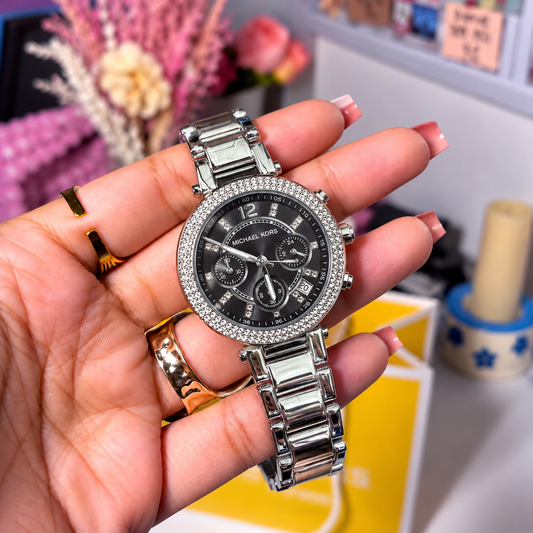 MK Parker Silver Black Dial women's watch held in hand, black dial with crystal-set bezel